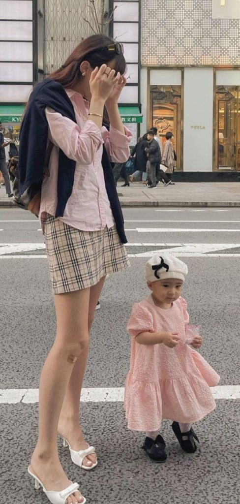 pink shirt and burberry skirt outfit